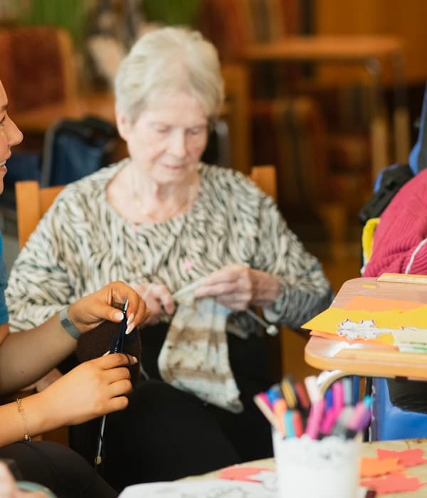 Caregiver supporting an elderly resident